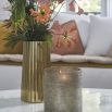 Elegant, tall golden vase with ribbed texture