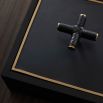 Black wooden box with brass details and cross handle