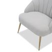 Light grey velvet chair with statement leaf backrest and tapered brass legs