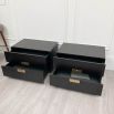 Pair of bedside tables with two drawers and brass details.