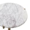 Poised and elegant side table with tripod design legs in textured brass finish with a round white marble top 