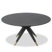 Dining table with statement base of slender spokes and brass caps