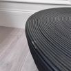 Round black coffee table with ribbed texture