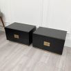 Pair of bedside tables with two drawers and brass details.