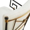 Black framed armchair with brass accents and linen seat and back cushions