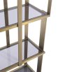 Elegant and glamorous shelving unit finished in brushed brass with geometric design