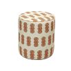 A luxury pouffe by Eva Sonaike with an orange African-inspired pattern