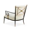 Black framed armchair with brass accents and linen seat and back cushions