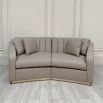 Stylish curved sofa with cobble leather upholstery and brass plinth base