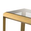Glamorous side table with brass frame and glass surfaces