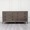 6-drawer chest of drawers with a brown oak finish and antique brass hardware 