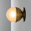 Charming brass wall light with round shade