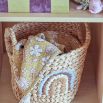 Two woven baskets with rainbow and mushroom