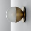 Charming brass wall light with round shade