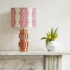 A luxury lampshade by Eva Sonaike Odi with a pink African-inspired pattern 