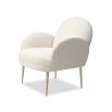 Artisan curved armchair finished in boucle sand with brass legs