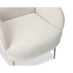 Artisan curved armchair finished in boucle sand with brass legs