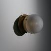 Charming brass wall light with round shade