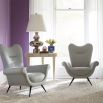 Icy blue linen armchair with swooping silhouette and black steel legs