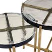 A stylish set of side tables with handmade glass tops and a vintage brass finish