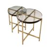 A stylish set of side tables with handmade glass tops and a vintage brass finish