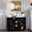 Black three-drawer chest with eclectic gold decorative elements