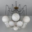 Striking chandelier with web-like suspension design and orb shades