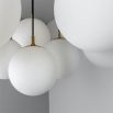 Striking chandelier with web-like suspension design and orb shades