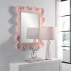 A beautiful wall mirror by Uttermost with a coral pink and organic shaped finish 