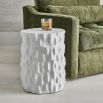 Textured tree trunk-like side table with chalky white finish