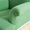 Green armchair with cream fringe bottom