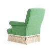 Green armchair with cream fringe bottom