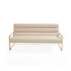 Upholstered beige sofa with brass detail