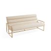 Upholstered beige sofa with brass detail