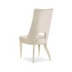 Neutral upholstered dining room chair with peak-through lower back