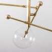 Industrial style 6 arm chandelier in a natural brass finish with 6 clear glass globe bulbs