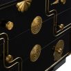 Black three-drawer chest with eclectic gold decorative elements