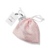 A glamorous silk eye mask with a rattan pink design on a gorgeous ivory background and complete with a drawstring pouch