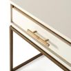 A stylish side table with a white high gloss varnish, a bamboo handle and finished with gold details