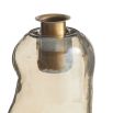 Free-form glass candleholders with a smoky luster finish and antique brass tops, shimmering in the light.