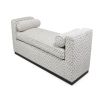 A luxurious bench with a seat cushion and bolster cushions 