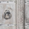 Ornately carved cabinet with washed wood finish