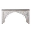 A captivating console table with a washed wood finish and intricate curves