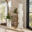 The Darnell Floor Sculpture’s geometric matte resin design is accented by a dynamic faux wood texture.