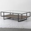 A luxurious two-tier coffee table with a  glass surface and wicker/mdf lower shelf