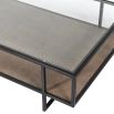 A luxurious two-tier coffee table with a  glass surface and wicker/mdf lower shelf