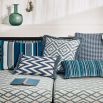 A gorgeous rectangular cushion with a blue and cream zig zag pattern, adorned with a fringe.