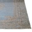 A luxurious blue rug with a jacquard pattern and distressed finish