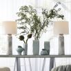 The Fisher Vases have botanical textures and an icy morn glaze, adding a refined touch to any space.