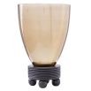 Warm toned glass vase with ribbed wooden base and three spherical feet